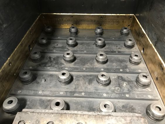 Schutzvorrichtung, bestehend aus 20 TUBUS Sicherheitsdämpfern der ACE Stoßdämpfer GmbH, auf denen die Schublade der Krätzesortieranlage im Betrieb gelagert ist.